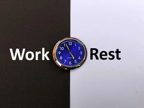 Clock on black and white background with print of the word work rest Stock Photos