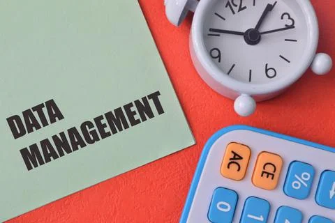 Clock, calculator and green note with text DATA MANAGEMENT Stockfoto's