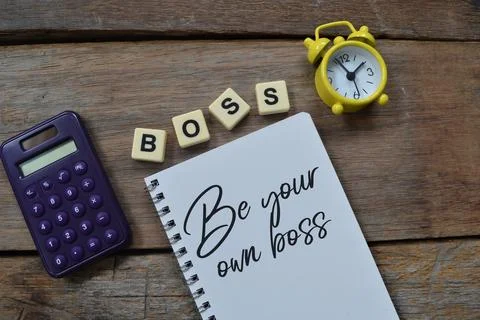 Clock, calculator, square letters with text BOSS and notebook written with BE Foto stock