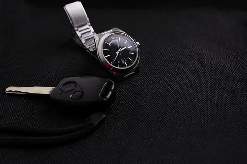 Clock with car keys, black background Stock Photos