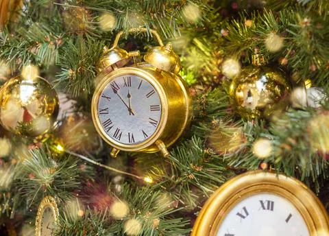 The clock on the Christmas tree. A symbol of the approaching New Year. Stock Photos