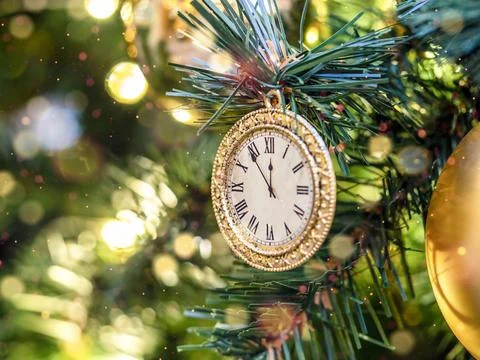 The clock on the Christmas tree. A symbol of the approaching New Year. Stock Photos