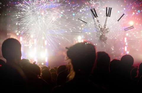 Clock close to midnight, fireworks and crowd waiting for new year Stock Photos