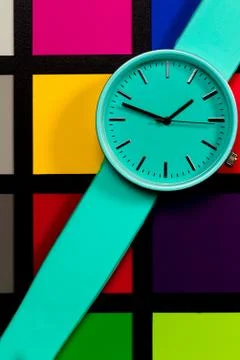 Clock on a  colored background. Abstraction. Minimalism Stock Photos