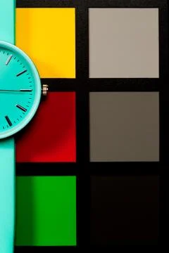 Clock on a  colored background. Abstraction. Minimalism Stock Photos