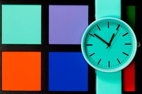 Clock on a  colored background. Abstraction. Minimalism Stock Photos