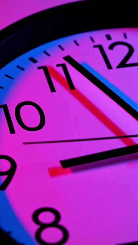 Clock face in blue and red lights. Time ticking on classic wall clock. Timelapse Stock Footage 302059699