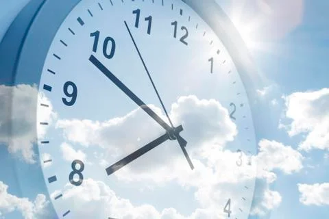 Clock face in blue sky Stock Photos