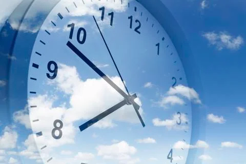 Clock face in blue sky Stock Photos