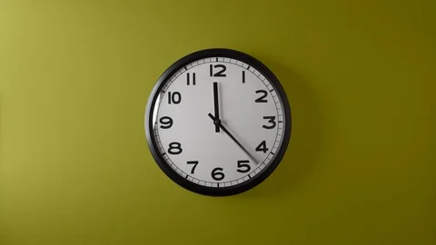 Clock Face Full Circle 12 hours on Cyan Magenta Yellow Till background Stock Footage