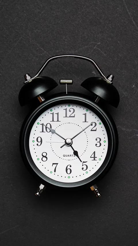 Clock face timelapse on black background. Time ticking on old fashioned clock Stockbeeldmateriaal 329433229