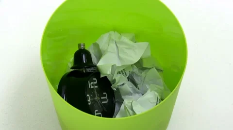 Clock falls inside trash can 03 Video stock 10129512