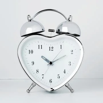Clock in the form of heart on a white background Stock-Fotos