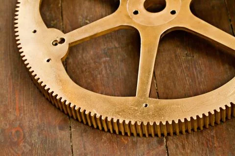 Clock gear, gold and wheel cog on a wood table with golden machinery and gears Stock Photos