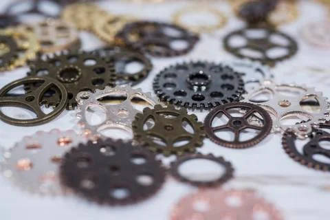 Clock gear wheels on table. Retro clock repairing abstract photo Stock Photos