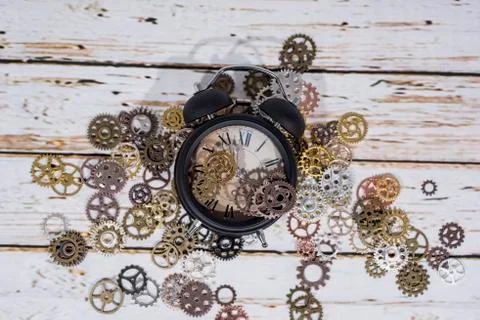Clock gear wheels on table. Retro clock repairing abstract photo Stock Photos