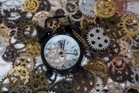 Clock gear wheels on table. Retro clock repairing abstract photo Stock Photos
