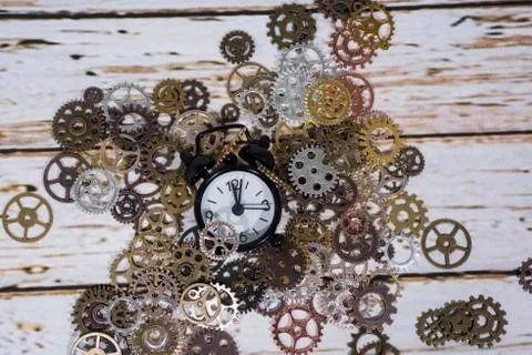 Clock gear wheels on table. Retro clock repairing abstract photo Stock Photos