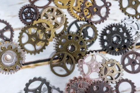 Clock gear wheels on table. Retro clock repairing abstract photo Stock Photos