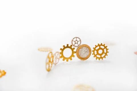 Clock gear wheels on white table with euro coins. Money currency abstract pho Stock Illustration