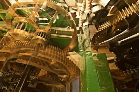 Clock, gears and machine wheel interior with brass mechanics and engine. Gear Stock Photos