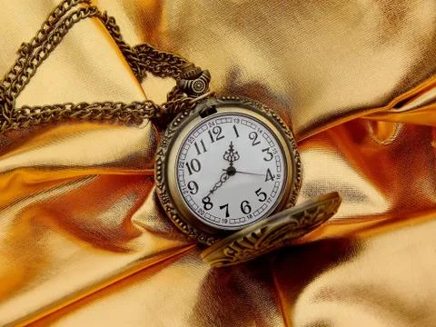 Clock on a gold background close-up. Tone-Mapped Image Stock Photos