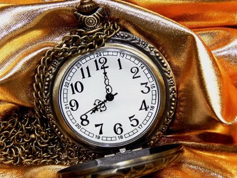 Clock on a gold background Stock Photos