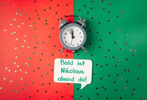 Clock is on a green background with a red background Stock Photos