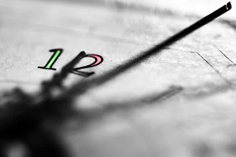 Clock hand approaching twelve macro conceptual abstract deadline image Stock Photos