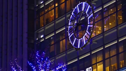 The clock hand of the illuminated large analog clock moving, station Stock Footage 240498235