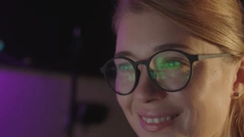Clock hand shows 12 o'clock at night close-up of female eyes in glasses with Stock Footage 259170161
