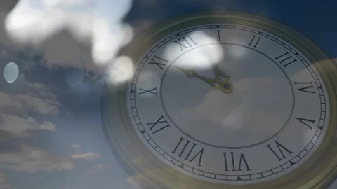 Clock hands advancing by ticking while clouds drifting causing lens flares Stockbeeldmateriaal 318194246