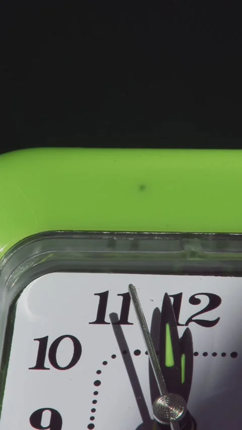 Clock hands approach twelve on white face with green frame. Stock Footage 339013092