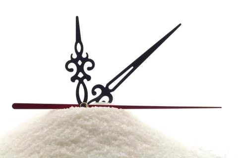 Clock hands on a mountain of sugar Stock Photos