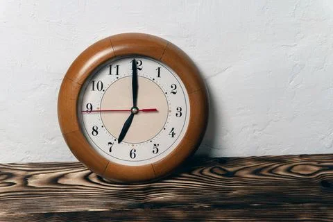 Clock with hands showing the time 7-00, seven o'clock in the morning, time to Stock Photos