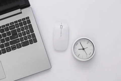 Clock with laptop on white background. Working Deadline. Top view. 写真素材