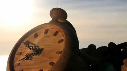 Clock left at sunset near sea shore zooming time lapse Stock Footage 76085186