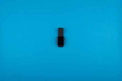 The clock lies on a blue background Stock Photos