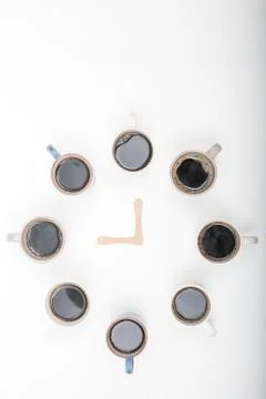Clock made of Eight cups of coffee on white background with copy space Stock Photos