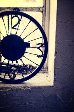 Clock made out of a bicycle wheel and bits of bike chain for numbers Stock Photos