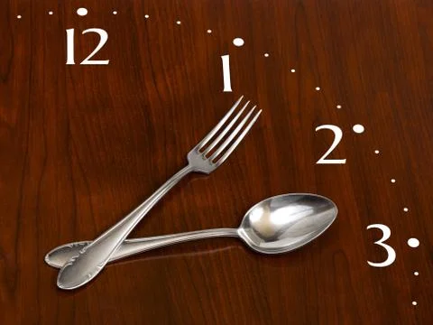 Clock made of spoon and fork Stock Photos