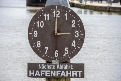 Clock marks the next departure date of a ferry Stock Photos