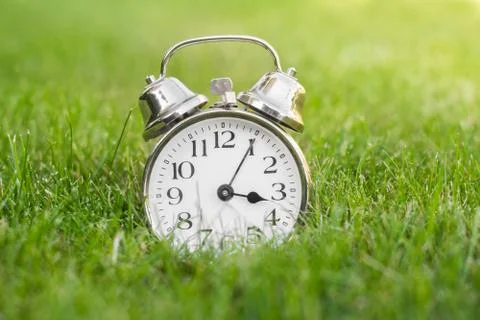 Clock on meadow Stock Photos