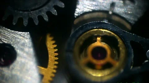 A clock mechanism with gears captured in macro with timelapse and slow motion Видео 333706582