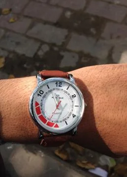 A clock in the middle of a watch Stock Photos