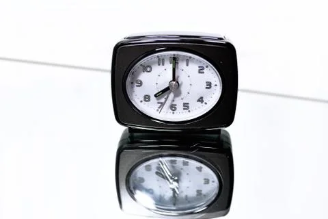 Clock on mirror with reflection. Stock Photos