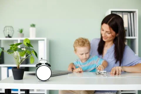 Clock mockup against background of working woman with a child Foto stock