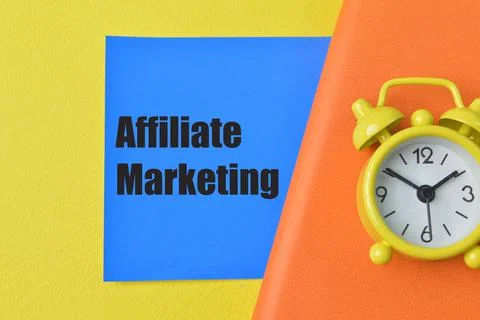 Clock, notebook and blue note with text AFFILIATE MARKETING Stock Photos
