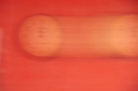 The clock is out of focus on a red background. Running time. Stock Photos