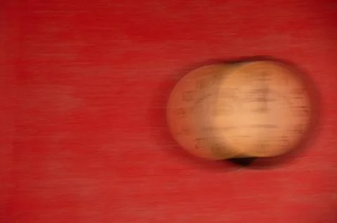 The clock is out of focus on a red background. Running time. Stock Photos